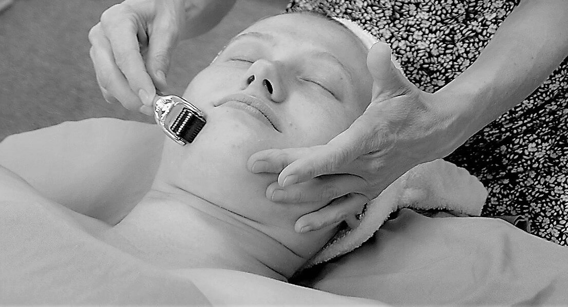 Heidi performing a facial treatment